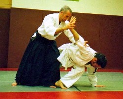 Praticante de aikido usando hakama (à esquerda)